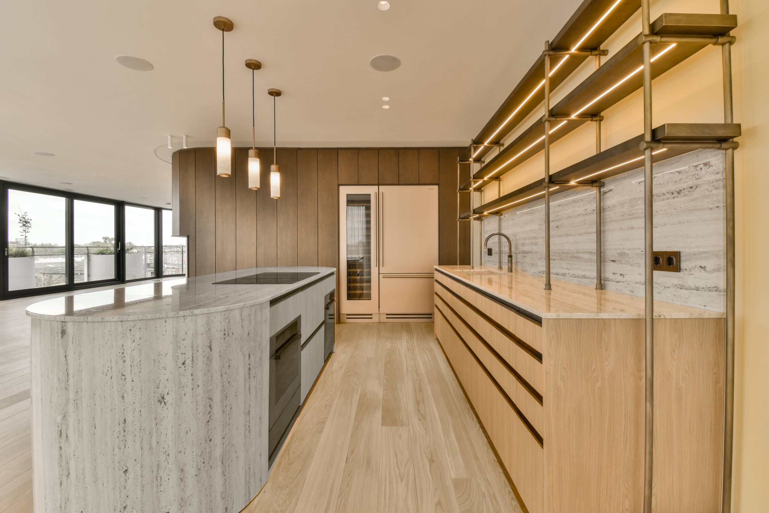 a modern kitchen with wood flooring and white marble countertops in the center of the room is large windows